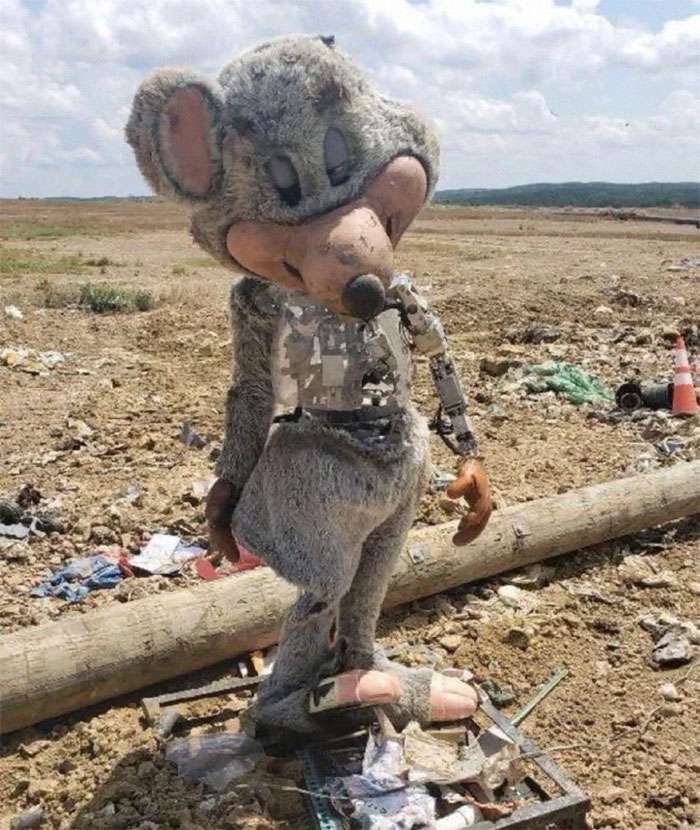 Alt: Chuck E. Cheese animatronic in a landfill