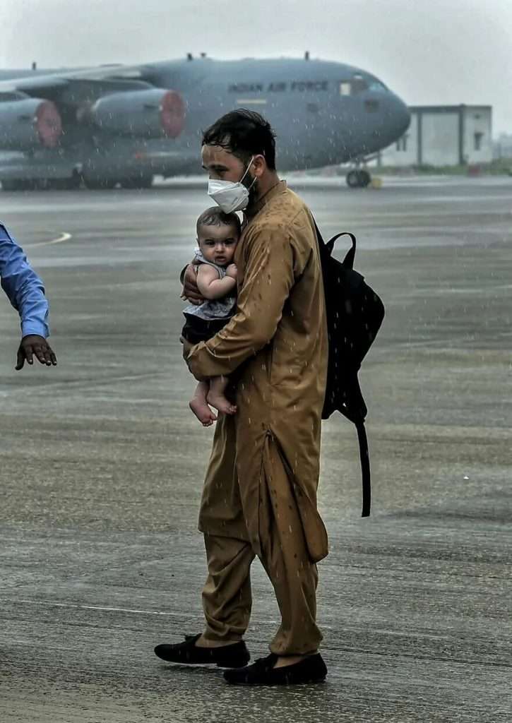 "A Portrait Of A Man Carrying A Child" By Arun Sharma/PTI