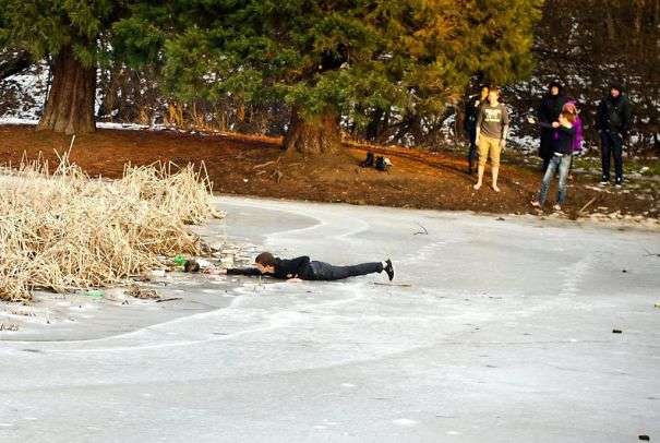 Alt: The teenage boy rescues a stray dog from drawing a frozen lake 