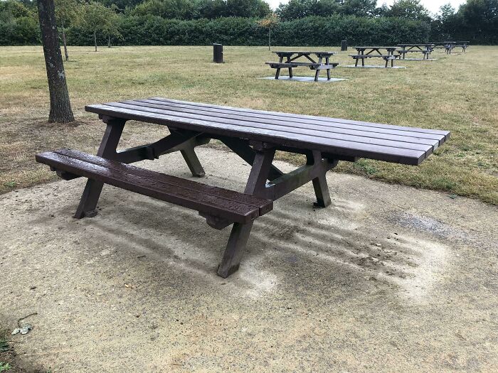 The picnic table has extended one side for wheelchair users