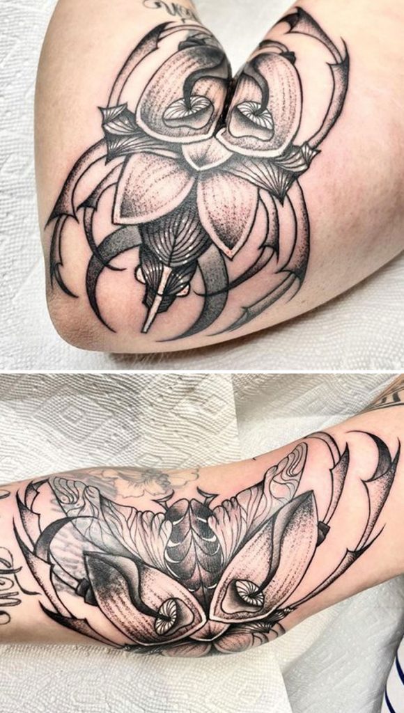 Scarab tattoo opens up with the arm movement