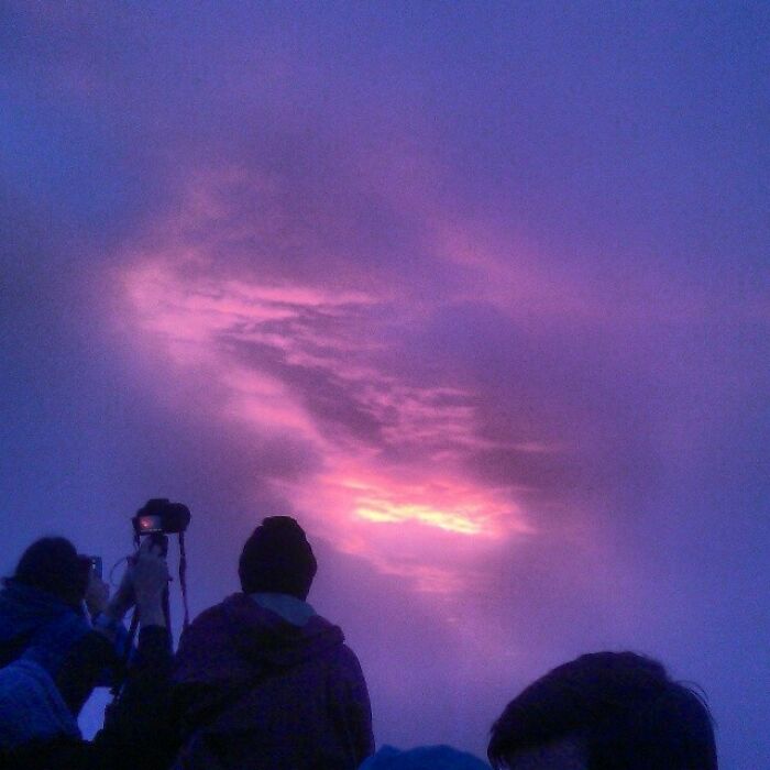 On top of a volcano, waiting for the daylight to materialize. This was the best view we saw because of the clouds.