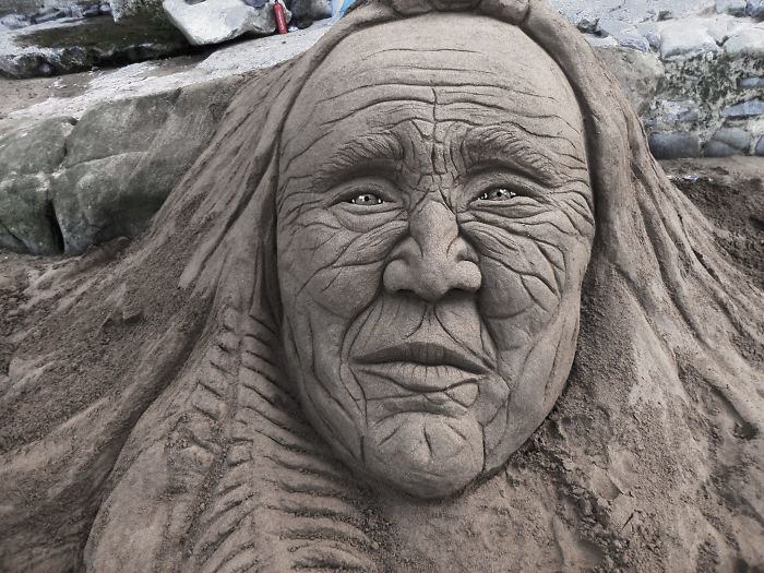 human face sand sculpture