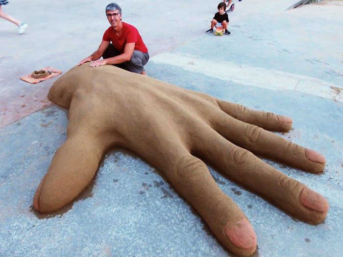 giant hand sand sculpture